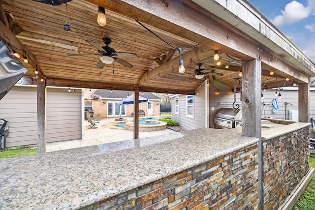 view of patio / terrace featuring area for grilling, a ceiling fan, and a pool with connected hot tub