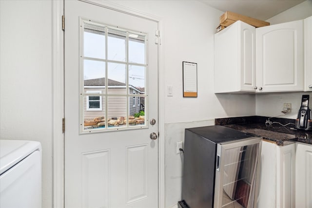 laundry area featuring cabinet space and beverage cooler