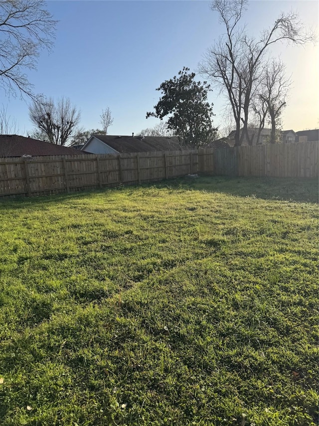 view of yard with a fenced backyard