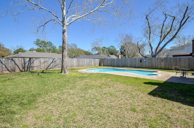 view of yard featuring a fenced in pool, a fenced backyard, and a patio area