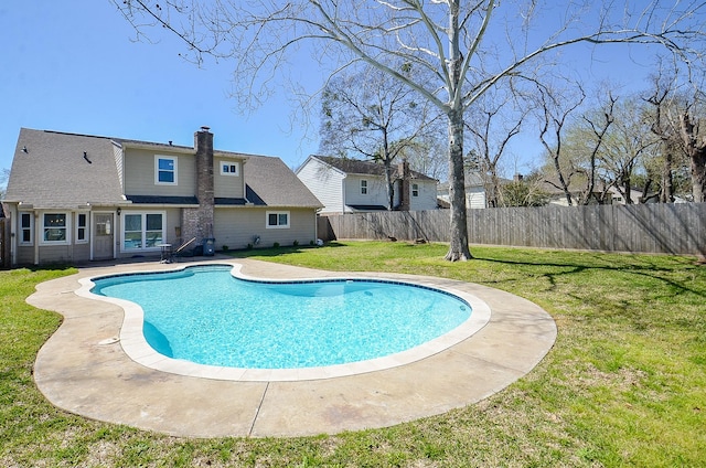 view of swimming pool featuring a fenced in pool, a lawn, and a fenced backyard