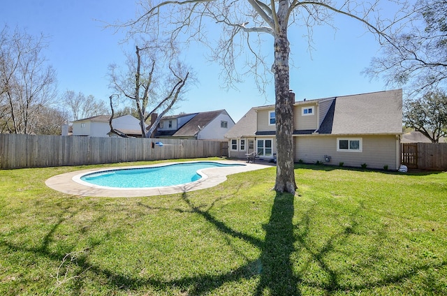 view of pool featuring a yard, a fenced in pool, a fenced backyard, and a patio area