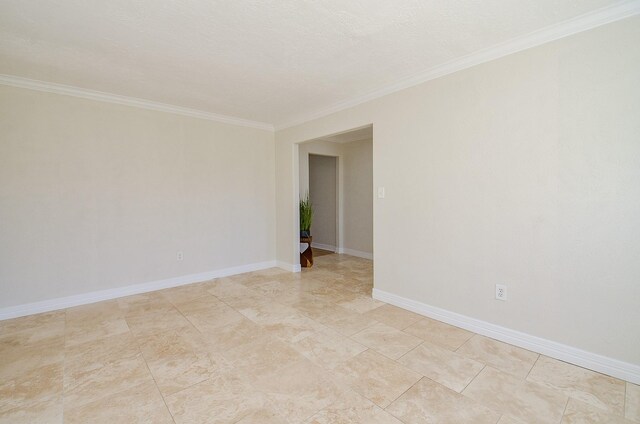 unfurnished room with a textured ceiling, crown molding, and baseboards