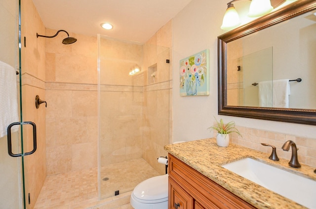 full bathroom featuring vanity, toilet, and a stall shower