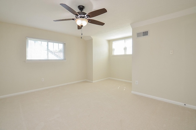 spare room with visible vents, baseboards, ceiling fan, and carpet flooring