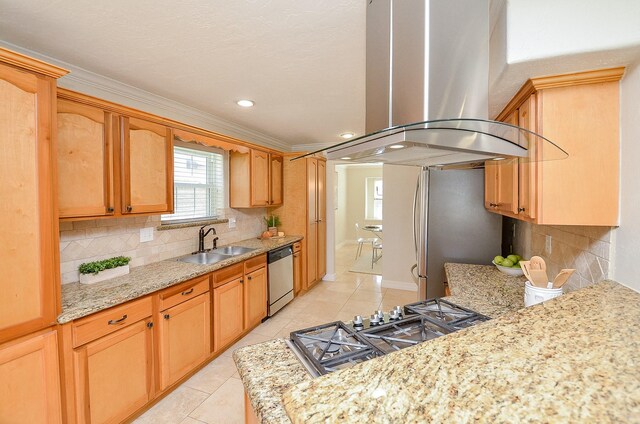 kitchen with light tile patterned flooring, a sink, decorative backsplash, appliances with stainless steel finishes, and island range hood