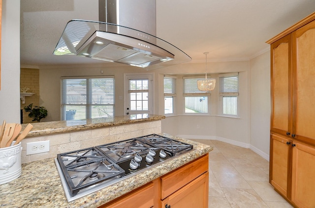 kitchen featuring stainless steel gas cooktop, light stone counters, extractor fan, and ornamental molding