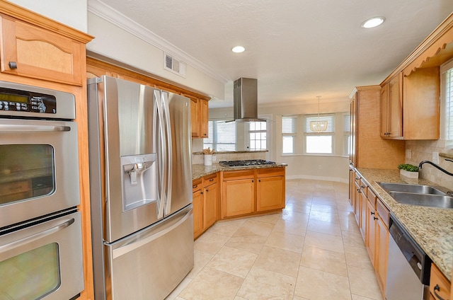 kitchen with island exhaust hood, a sink, tasteful backsplash, appliances with stainless steel finishes, and crown molding