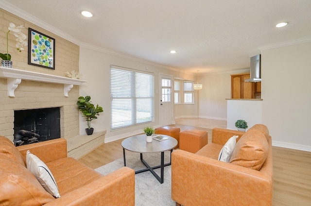 living room with light wood-type flooring, baseboards, a brick fireplace, and crown molding