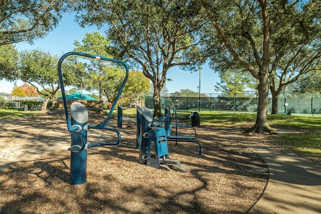 view of community featuring playground community and fence