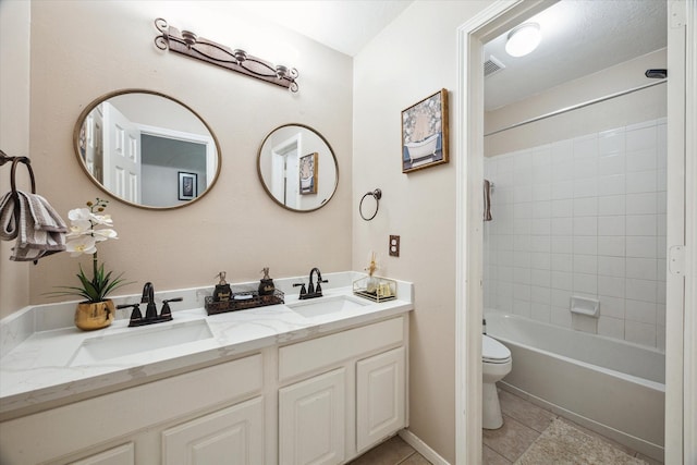 full bathroom with a sink, visible vents, toilet, and double vanity