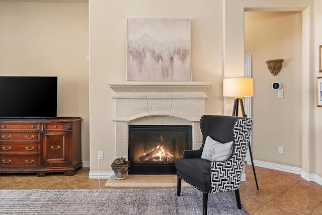 sitting room featuring tile patterned floors, baseboards, and a tile fireplace