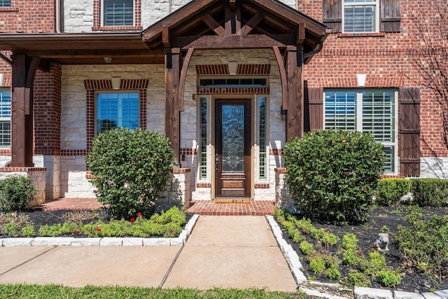 entrance to property with stone siding and brick siding