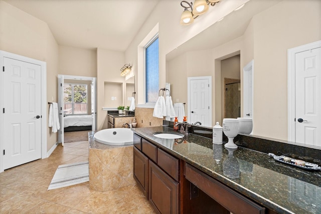 bathroom with a washtub, an enclosed shower, connected bathroom, vanity, and tile patterned floors