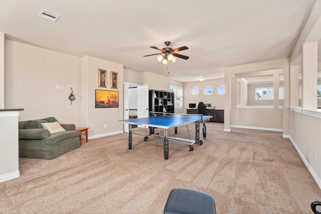 recreation room featuring carpet floors, baseboards, visible vents, and a wealth of natural light