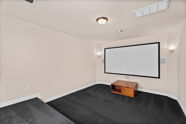 cinema with visible vents, dark carpet, and baseboards