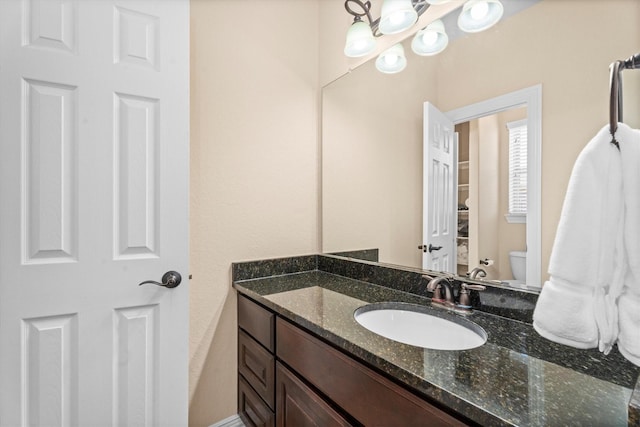 bathroom with toilet and vanity