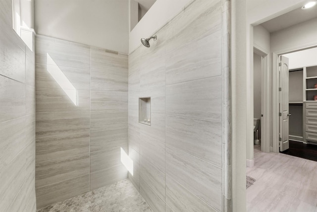 bathroom with tiled shower