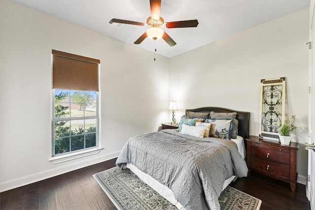 bedroom featuring a ceiling fan, baseboards, and wood finished floors