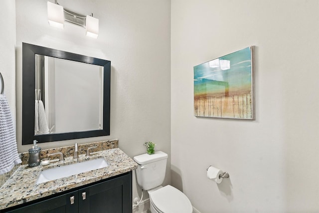 bathroom featuring toilet and vanity