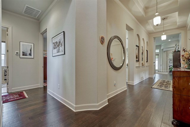 hallway with baseboards, visible vents, dark wood finished floors, and crown molding