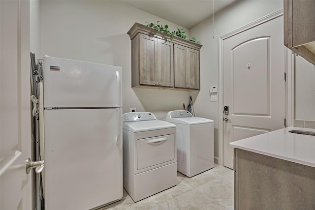 washroom featuring cabinet space and washer and dryer