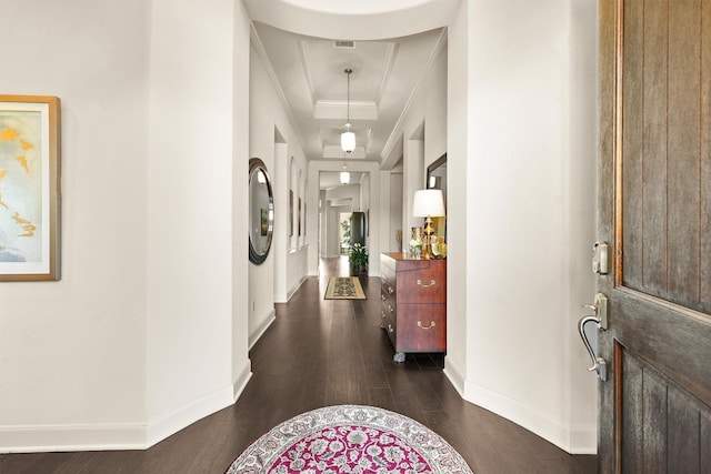 foyer entrance featuring ornamental molding, dark wood-type flooring, visible vents, and baseboards