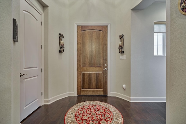 entrance foyer with baseboards and dark wood finished floors