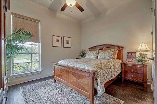 bedroom featuring baseboards, dark wood finished floors, and a ceiling fan