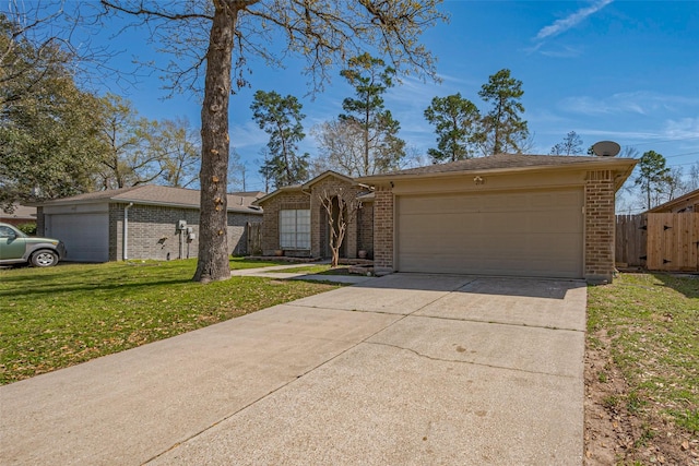 view of front facade featuring brick siding, an attached garage, fence, driveway, and a front lawn