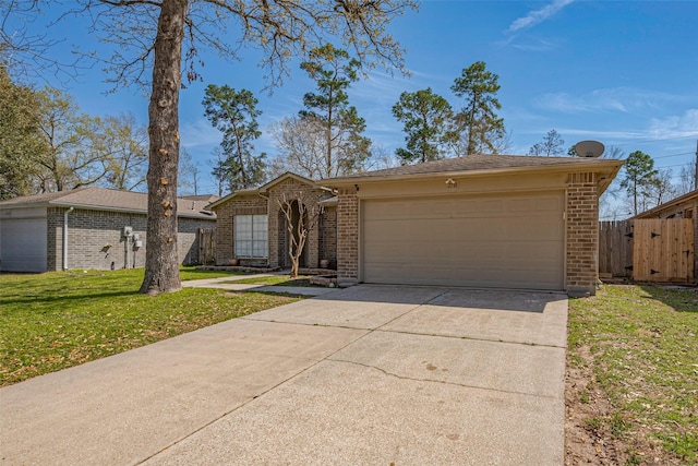 view of front of house with a garage, concrete driveway, brick siding, and fence