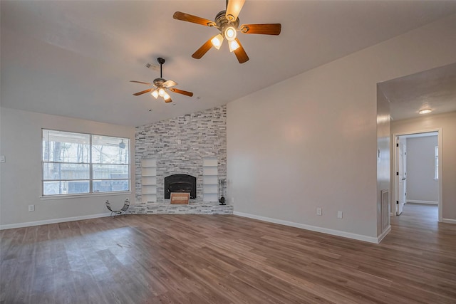 unfurnished living room featuring lofted ceiling, a fireplace, baseboards, and wood finished floors