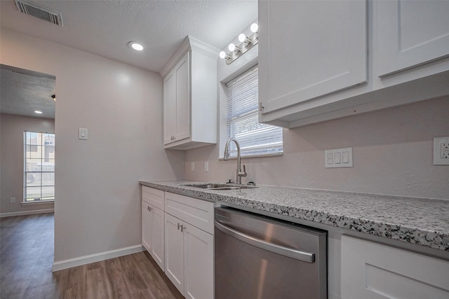 kitchen with a textured ceiling, a sink, visible vents, white cabinetry, and stainless steel dishwasher