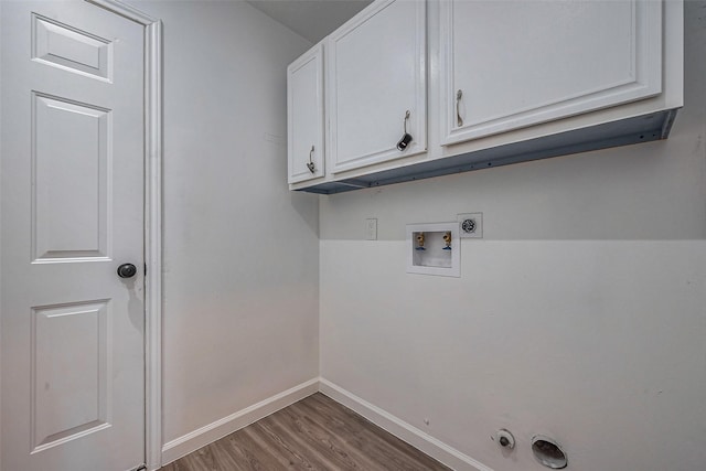 washroom featuring hookup for a washing machine, wood finished floors, baseboards, cabinet space, and electric dryer hookup