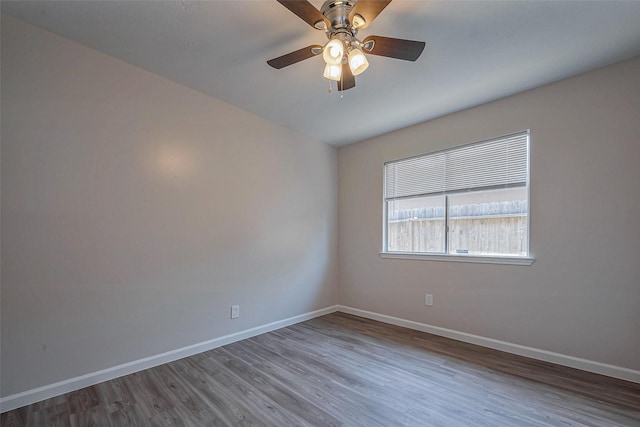 unfurnished room featuring ceiling fan, baseboards, and wood finished floors