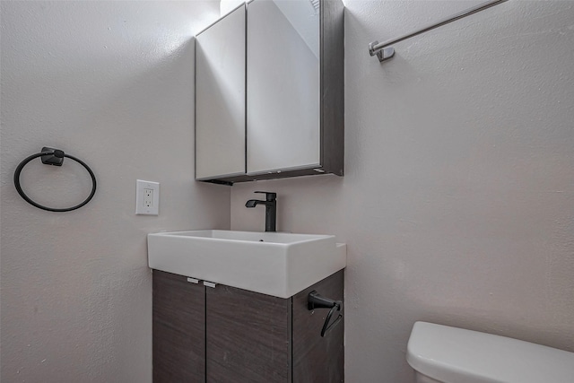 bathroom with toilet and a sink