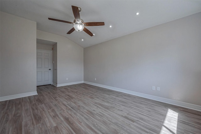 spare room with recessed lighting, vaulted ceiling, ceiling fan, wood finished floors, and baseboards