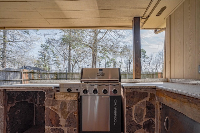 view of patio with fence, an outdoor kitchen, and area for grilling