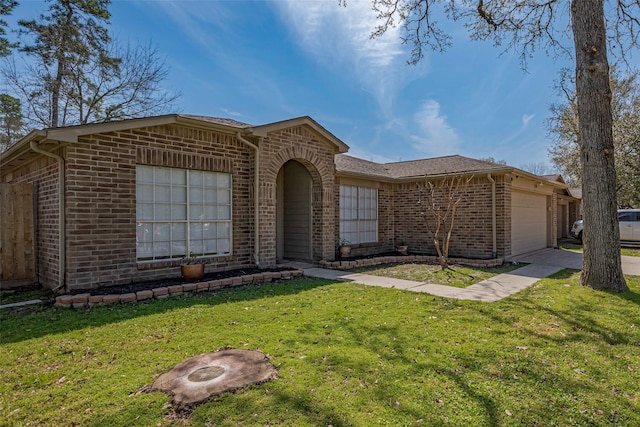 ranch-style house featuring an attached garage, a front yard, concrete driveway, and brick siding