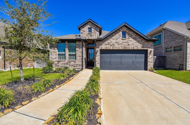 view of front of house featuring a garage, brick siding, concrete driveway, and a front lawn