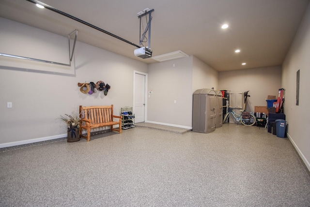 garage with recessed lighting, a garage door opener, and baseboards