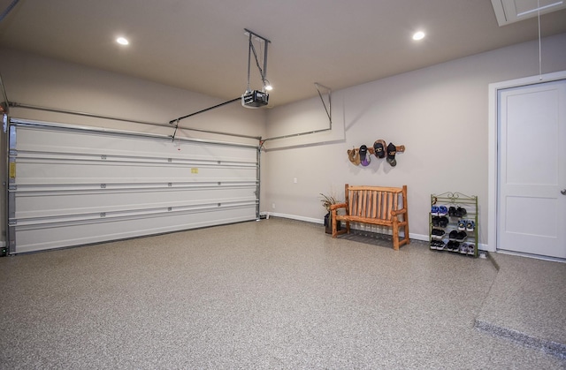 garage featuring a garage door opener, recessed lighting, and baseboards