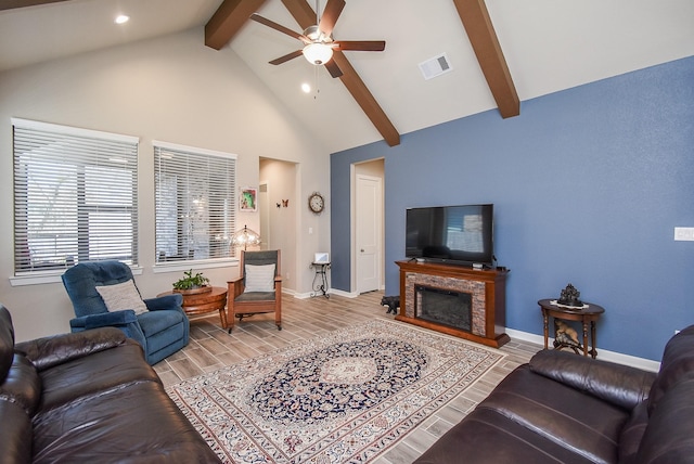 living area featuring visible vents, beam ceiling, high vaulted ceiling, a ceiling fan, and wood tiled floor