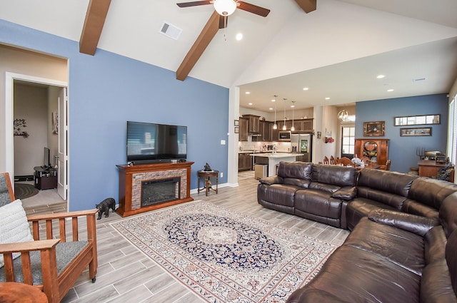 living room featuring visible vents, beam ceiling, high vaulted ceiling, ceiling fan with notable chandelier, and wood tiled floor