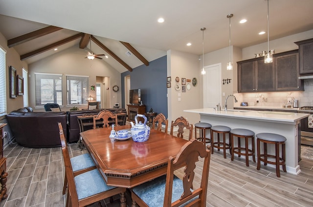 dining area featuring beamed ceiling, high vaulted ceiling, recessed lighting, ceiling fan, and wood tiled floor