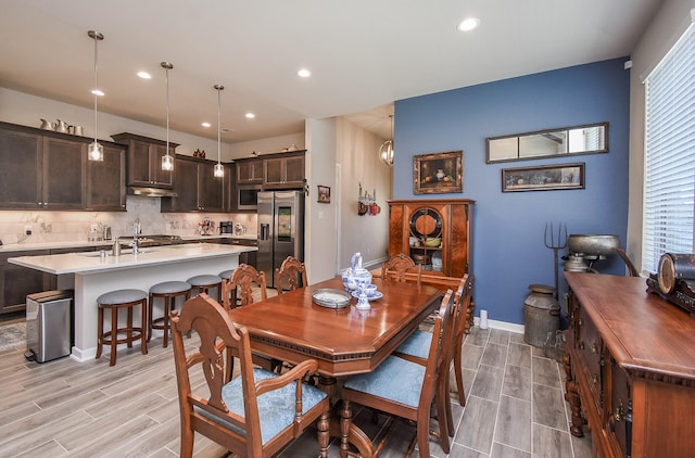 dining room featuring wood finish floors, baseboards, and recessed lighting