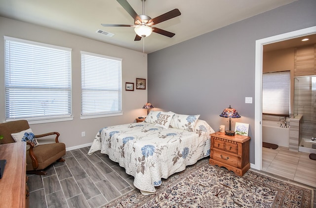 bedroom with visible vents, ceiling fan, ensuite bath, and baseboards