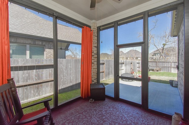 sunroom / solarium with a ceiling fan