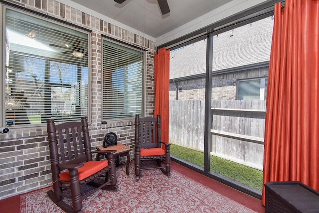 sunroom with a wealth of natural light and ceiling fan