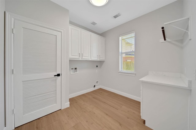 laundry area with cabinet space, light wood finished floors, visible vents, hookup for an electric dryer, and washer hookup